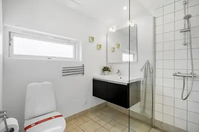 a bathroom with a toilet and a sink and a shower at JB221-Brovst-Kronvildtvej-182 in Brovst