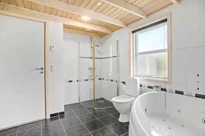 a white bathroom with a tub and a toilet at JB888-Fjerritslev-Aspevej-15 in Fjerritslev