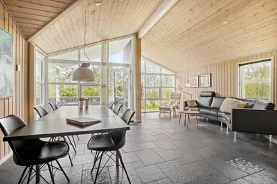 a living room with a table and chairs at JB888-Fjerritslev-Aspevej-15 in Fjerritslev