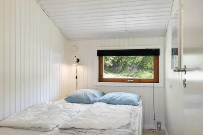 a bed in a small room with a window at JB272-Fjerritslev-Ronnevej-14 in Fjerritslev