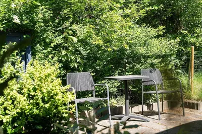 two chairs and a table in a garden at JB272-Fjerritslev-Ronnevej-14 in Fjerritslev