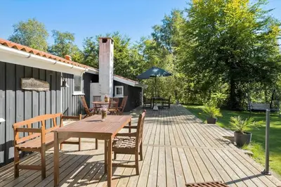 a wooden deck with a wooden table and chairs at JB179-Fjerritslev-Slojbrovej-77 in Fjerritslev