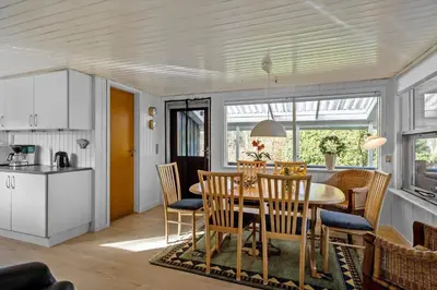 a kitchen and dining room with a table and chairs at JB179-Fjerritslev-Slojbrovej-77 in Fjerritslev