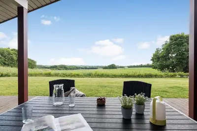 a wooden table with a view of a field at JB188-Fjerritslev-Kollerup-Klitvej-163 in Fjerritslev