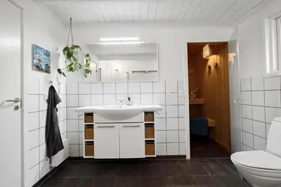 a white bathroom with a sink and a toilet at JB231-Fjerritslev-Poppelvej-2 in Fjerritslev
