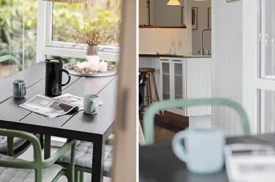 a kitchen with a table and a table and chairs at JB231-Fjerritslev-Poppelvej-2 in Fjerritslev