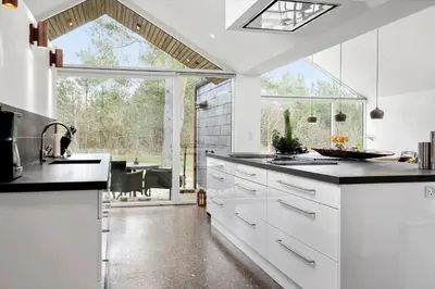 a kitchen with white cabinets and a large window at JB718-Fjerritslev-Tyttebaerstien-38 in Fjerritslev