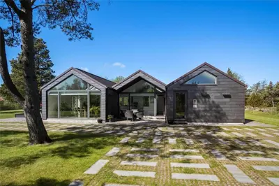a house with glass doors and a tree at JB718-Fjerritslev-Tyttebaerstien-38 in Fjerritslev