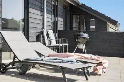 a pair of lounge chairs sitting on a patio at JB172-Brovst-Kronvildtvej-110 in Brovst