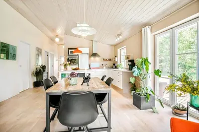 a kitchen and dining room with a table and chairs at JB295-Brovst-Ildervej-7 in Brovst