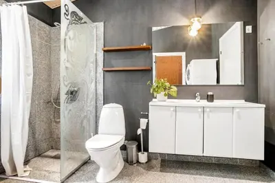 a bathroom with a white toilet and a sink at JB295-Brovst-Ildervej-7 in Brovst