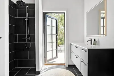a bathroom with a shower and a sink and a mirror at JB330-Fjerritslev-Perikumvej-12 in Fjerritslev