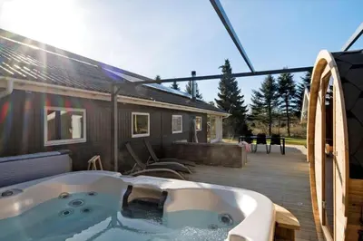 a bath tub sitting on a deck next to a building at JB195-Fjerritslev-Bogevej-36 in Fjerritslev