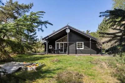 a log cabin with a porch and a yard at JB228-Brovst-Ildervej-14 in Brovst