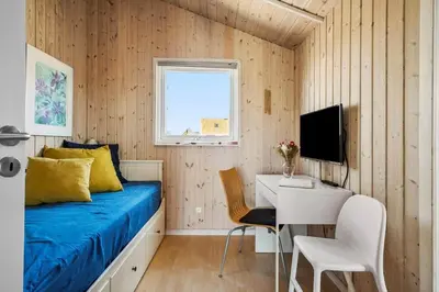 a bedroom with a bed and a desk and a television at JB230-Frostrup-Grabakkevej-4 in Frøstrup