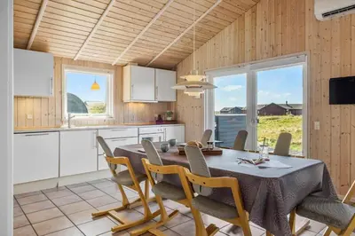 a kitchen and dining room with a table and chairs at JB230-Frostrup-Grabakkevej-4 in Frøstrup