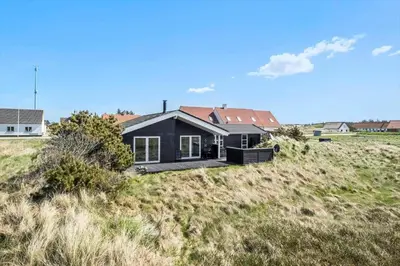 a black house on a hill in a field at JB230-Frostrup-Grabakkevej-4 in Frøstrup