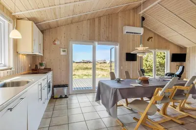 a kitchen and dining room with a table and chairs at JB230-Frostrup-Grabakkevej-4 in Frøstrup