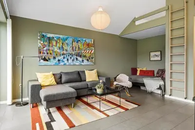 a living room with a couch and a painting on the wall at JB308-Fjerritslev-Slettestrandvej-134-lejl-3 in Fjerritslev