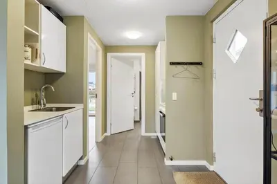 a kitchen with white cabinets and a hallway at JB308-Fjerritslev-Slettestrandvej-134-lejl-3 in Fjerritslev