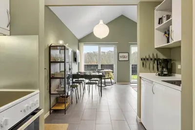 a kitchen with a table and chairs in it at JB308-Fjerritslev-Slettestrandvej-134-lejl-3 in Fjerritslev