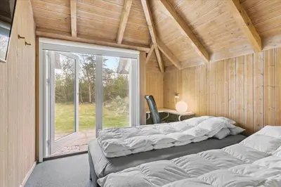 a room with two beds in a room with a window at JB149-Fjerritslev-Tulipanvej-23 in Fjerritslev