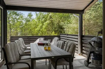 a wooden table and chairs on a screened porch at JB351-Fjerritslev-Revlingestien-77 in Fjerritslev