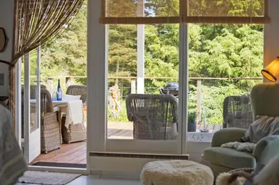 a living room with an open door to a patio at JB401-Brovst-Solsortevej-1 in Brovst