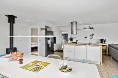 a kitchen and living room with a table and chairs at JB400-Brovst-Solsortevej-7 in Brovst