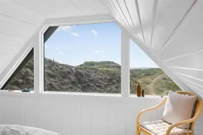 a window in a room with a chair in front of it at 850-Thisted-Sandvej-19 in Thisted