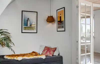 a living room with a couch and pictures on the wall at 2 Bedroom Amazing Home In Thyholm in Thyholm