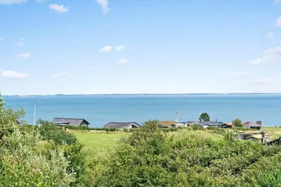 a group of houses on a hill next to the ocean at G228-Lemvig-Myntevej-28 in Lemvig