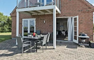 a patio with a table and chairs and a grill at Pet Friendly Home In Vestervig With Sauna in Vestervig