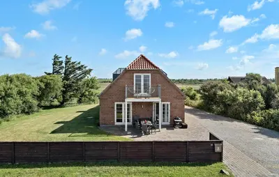 a brick house with a balcony on the front of it at Pet Friendly Home In Vestervig With Sauna in Vestervig