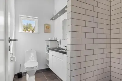 a white bathroom with a toilet and a sink at JB403-Fjerritslev-Poppelvej-20 in Fjerritslev