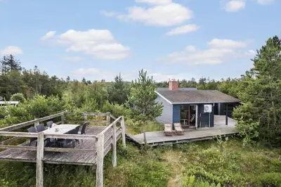 a tiny house in the woods with a deck at JB363-Fjerritslev-Tolderstien-8 in Fjerritslev