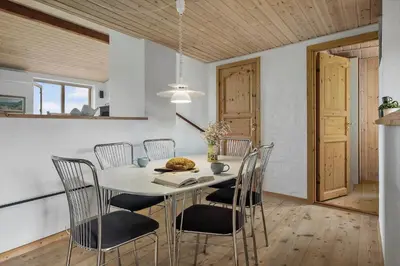 a dining room with a white table and chairs at JB363-Fjerritslev-Tolderstien-8 in Fjerritslev