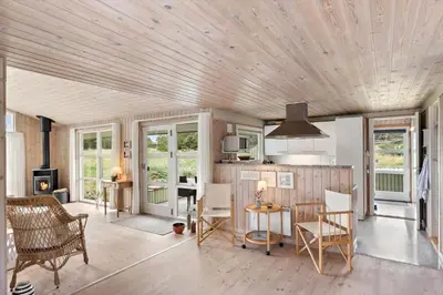 a living room with a wooden ceiling at LK2178-Lokken-Sarasvej-48 in Løkken