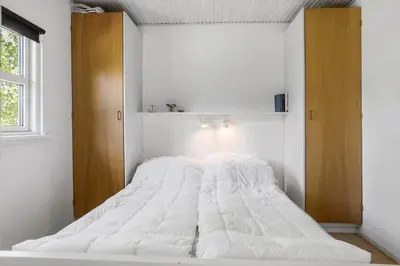 a large white bed in a room with a window at LF21632-Spottrup-Rylevej-1 in Spottrup