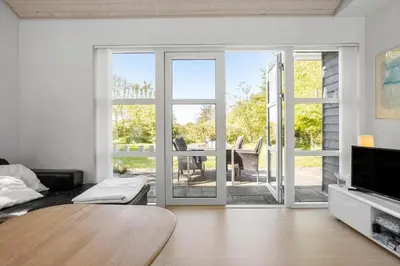 a living room with a table and a sliding glass door at LF21632-Spottrup-Rylevej-1 in Spottrup