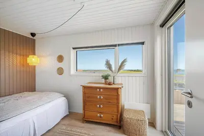 a bedroom with a bed and a dresser and a window at G322-Lemvig-Gyvelvej-22 in Lemvig