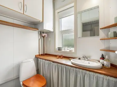 a bathroom with a sink and a mirror at Holiday Home Anja - 550m to the fjord by Interhome in Vemb