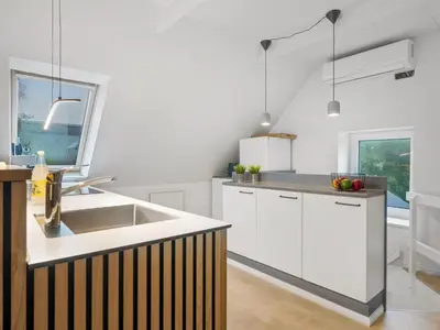 a kitchen with white cabinets and a sink at Holiday Home Raika - 25m to the fjord by Interhome in Vestervig
