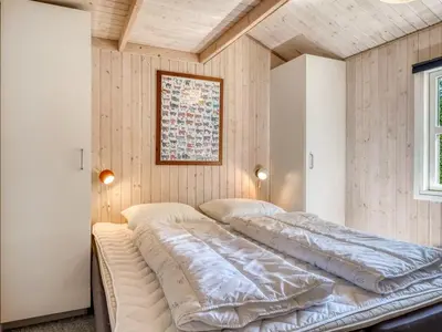 two beds in a room with wooden walls at Holiday Home Elizabeth - 150m to the fjord by Interhome in Fur