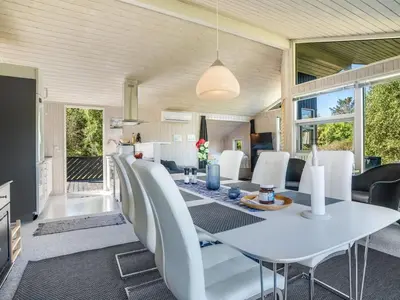 a dining room with a white table and white chairs at Holiday Home Marisol - 250m to the fjord by Interhome in Fur