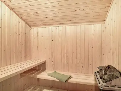 a wooden sauna with a bench in it at Holiday Home Marisol - 250m to the fjord by Interhome in Fur
