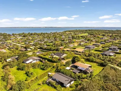 an aerial view of a small village next to the water at Holiday Home Berner - 500m to the fjord by Interhome in Roslev