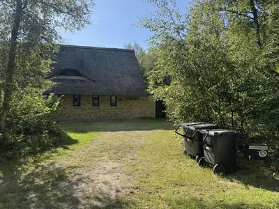an old house with two appliances sitting in front of it at Holiday Home Karmen - 1km from the sea by Interhome in Pandrup