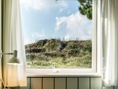 a window with a view of a field of grass at Apartment Enwald - 700m from the sea by Interhome in Pandrup
