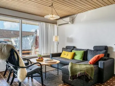 a living room with a couch and a table at Apartment Enwald - 700m from the sea by Interhome in Pandrup